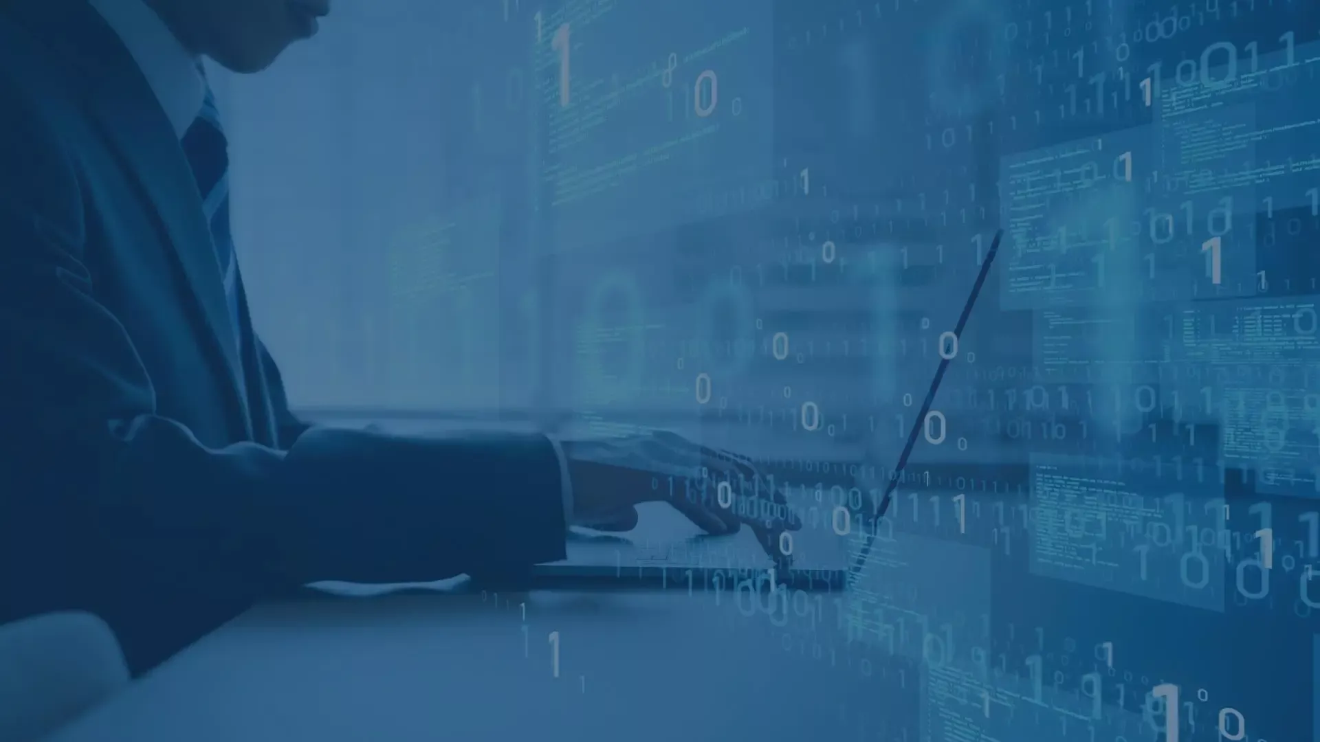 Mann in Anzug arbeitet am Laptop, überlagert von binärem Code, symbolisiert digitale Transformation und IT-Kompetenz.